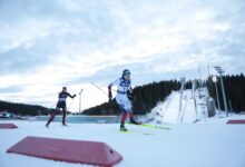 Cross-country skiers racing on a snowy Nordic course